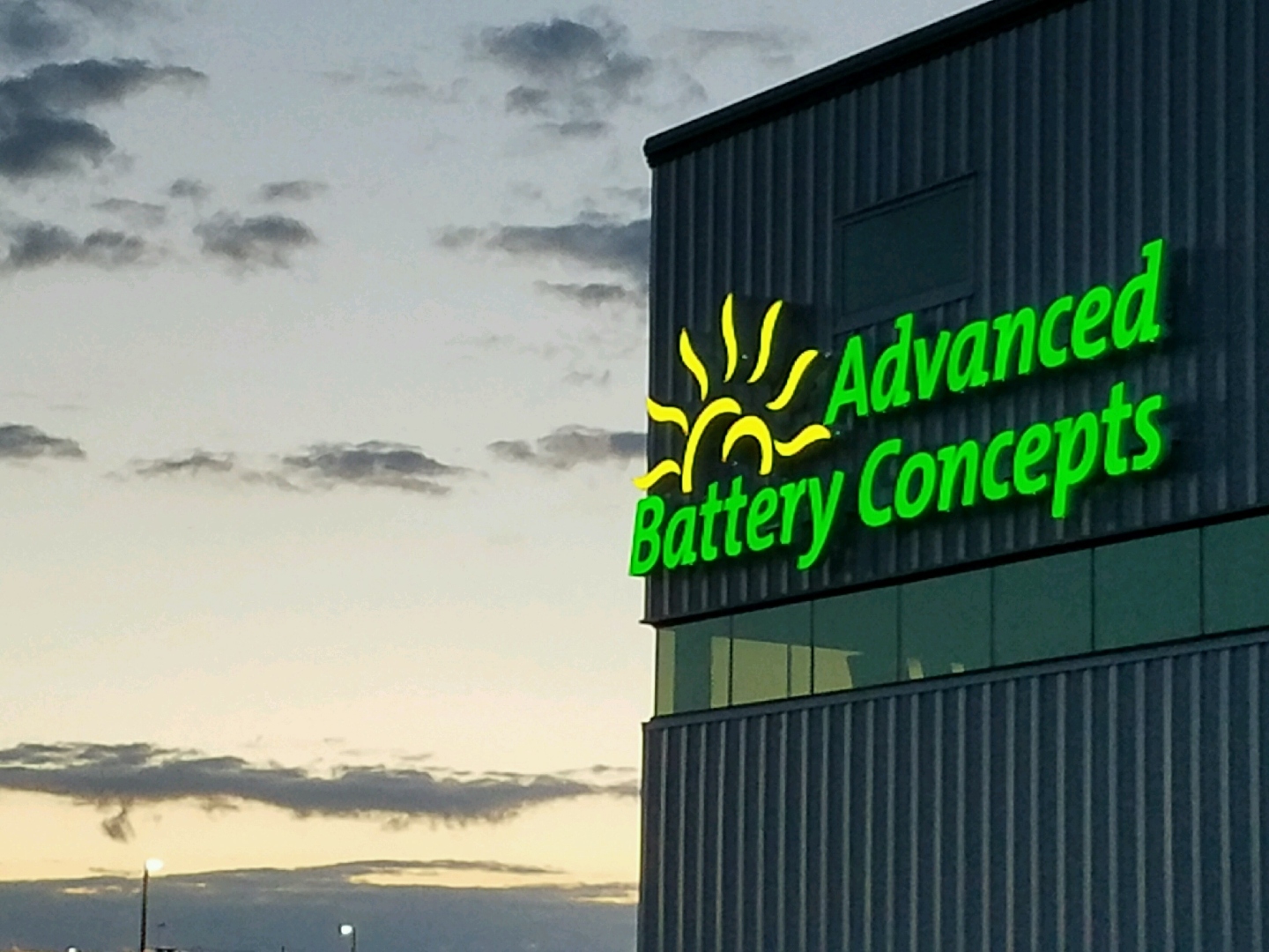 Advanced Battery Concepts illuminated building sign at dusk, Clare, Michigan