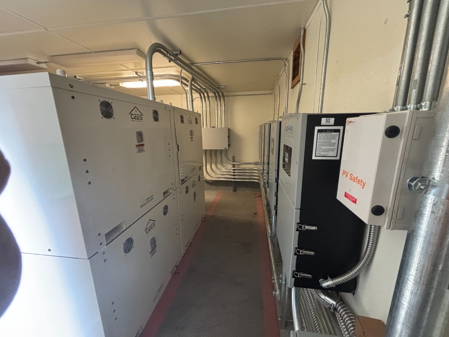 CEES units stacked with Sol-Ark inverters and conduit routing at Manitou Islands installation